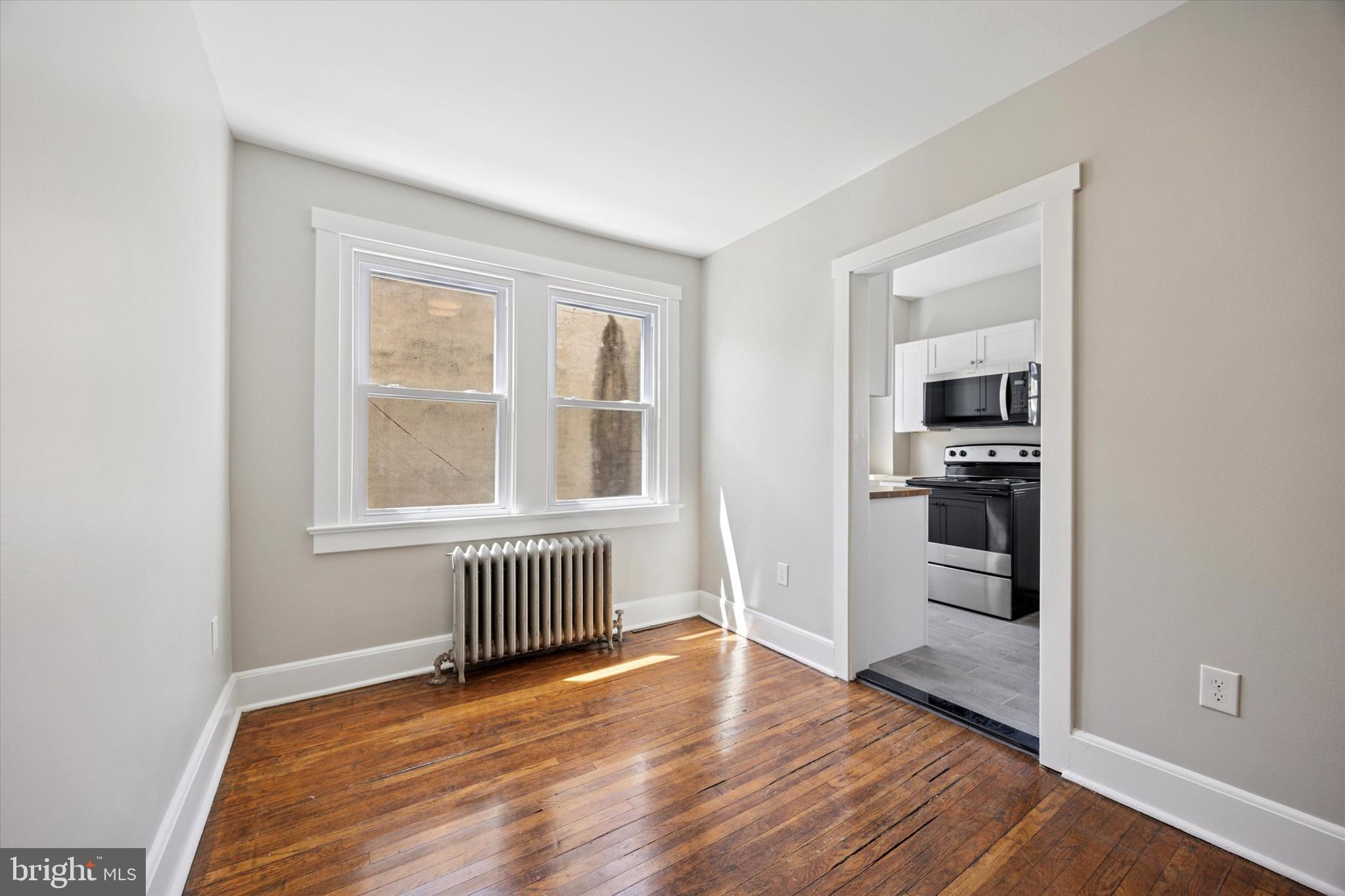 241 Haverford Avenue, Unit 3 Narberth, PA 19072 - Photo 10 of 13 wooden floor in an empty room with a window