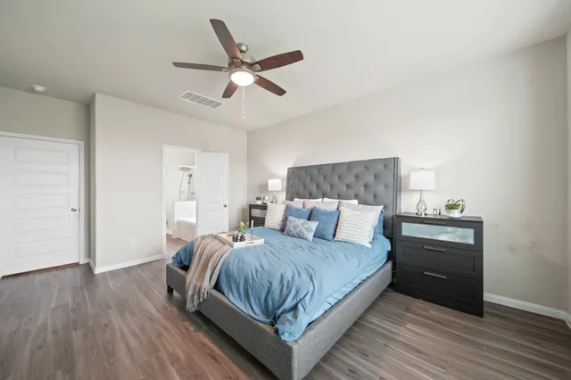 a bathroom with a granite countertop sink a mirror and a bathtub