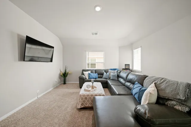 a view of a livingroom with workspace and a window