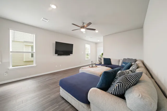 a spacious bedroom with a bed and a flat screen tv