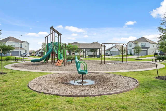 a street sign on a sidewalk next to a road