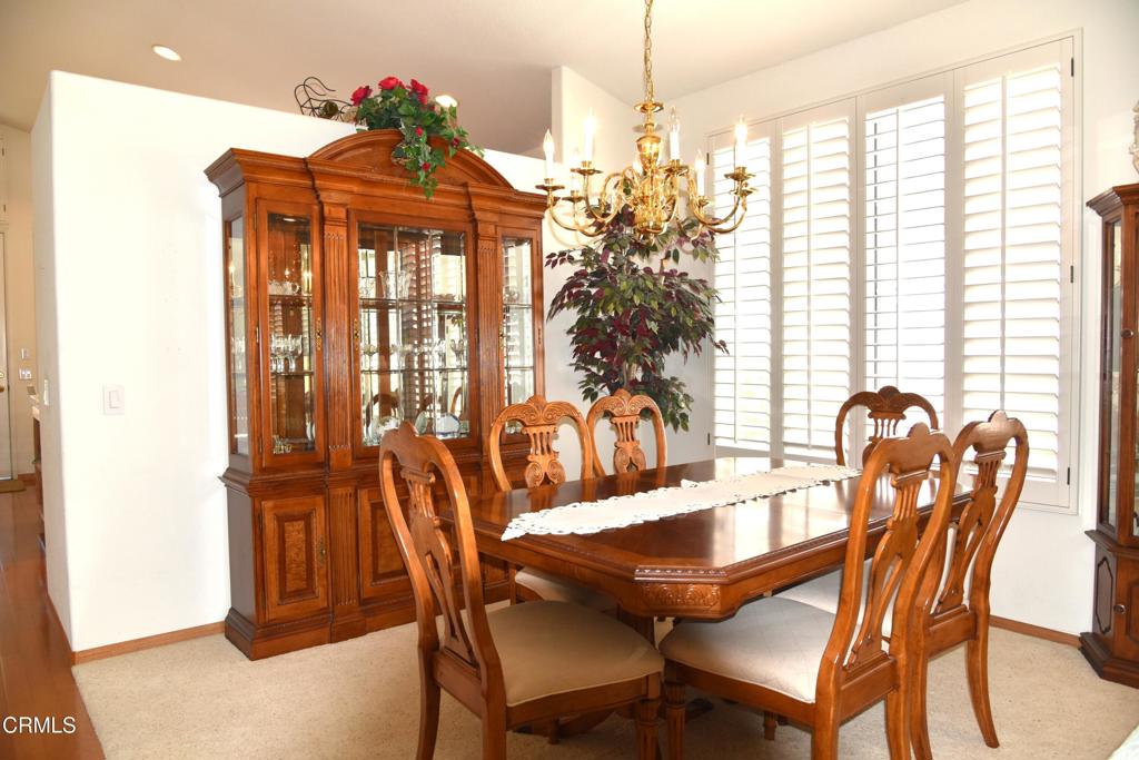 23805 Vía Compadres Murrieta, CA 92562 - Photo 3 of 13 a view of a dining room with furniture and chandelier