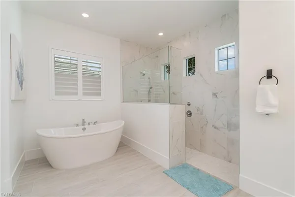 a bathroom with a white tub shower