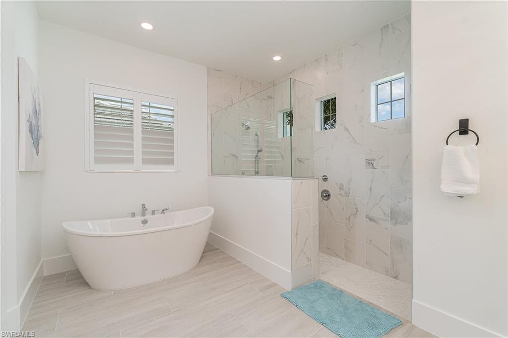8900 Nevis Way Naples, FL 34112 - Photo 15 of 34 a bathroom with a white tub shower