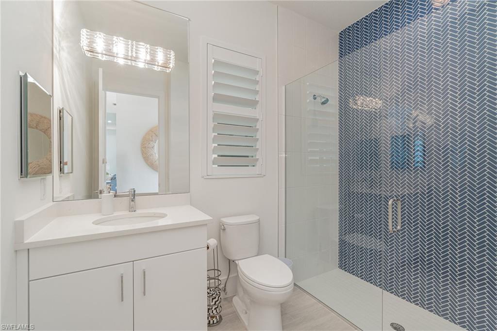 8900 Nevis Way Naples, FL 34112 - Photo 22 of 34 a bathroom with a sink toilet and shower