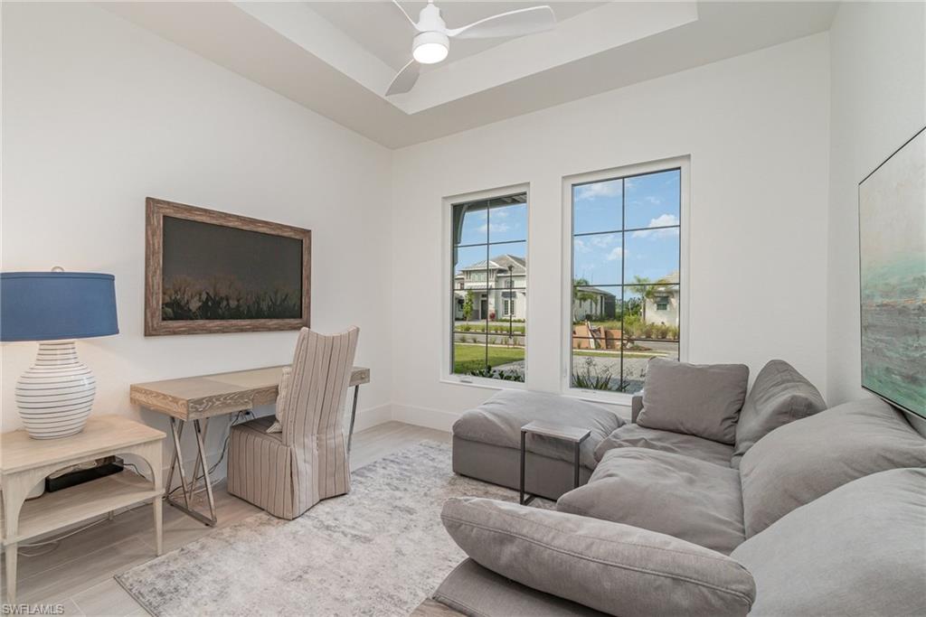 8900 Nevis Way Naples, FL 34112 - Photo 24 of 34 a living room with furniture and a flat screen tv