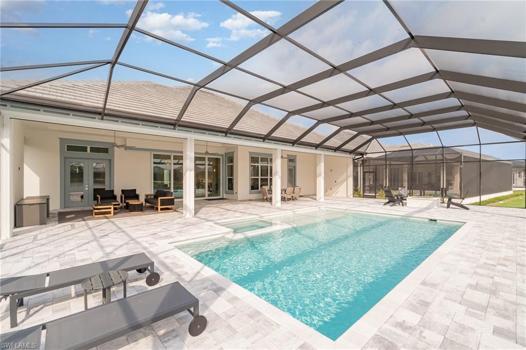 8900 Nevis Way Naples, FL 34112 - Photo 30 of 34 a view of a house with backyard porch and sitting area