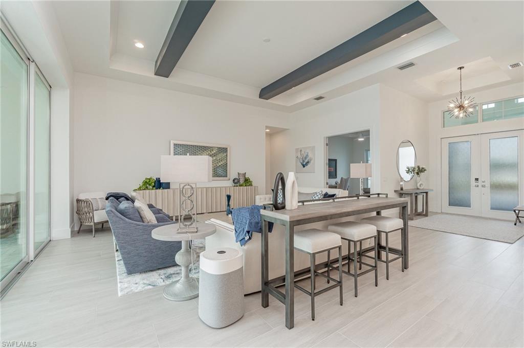 8900 Nevis Way Naples, FL 34112 - Photo 3 of 34 a dining room with furniture and wooden floor