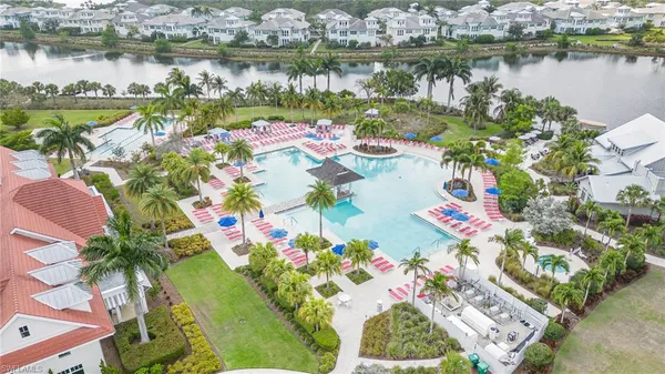 an aerial view of lake residential house with outdoor space and seating around