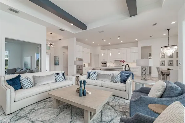 a living room with furniture and view of kitchen