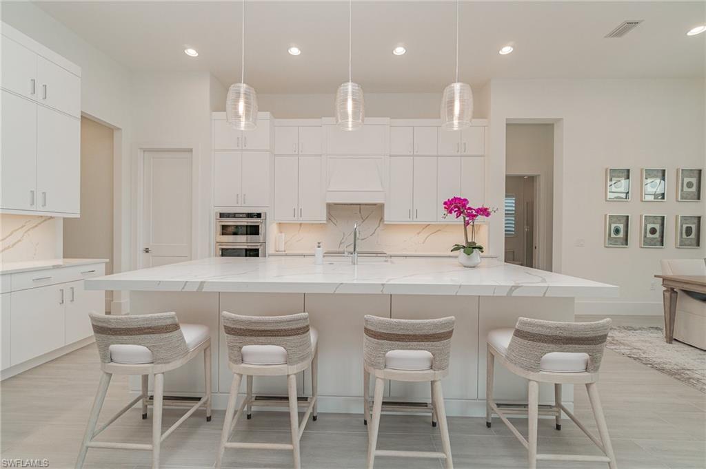 8900 Nevis Way Naples, FL 34112 - Photo 5 of 34 a kitchen with a sink and cabinets