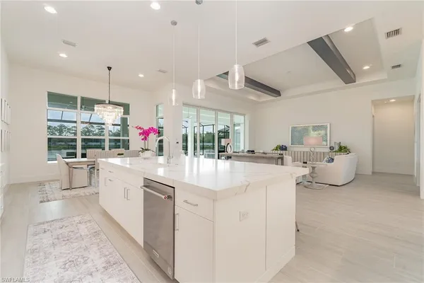 a large white kitchen with a large window