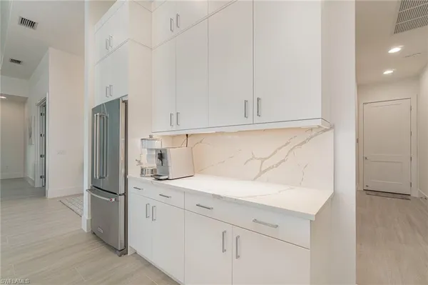 a kitchen with stainless steel appliances granite countertop a refrigerator and a sink