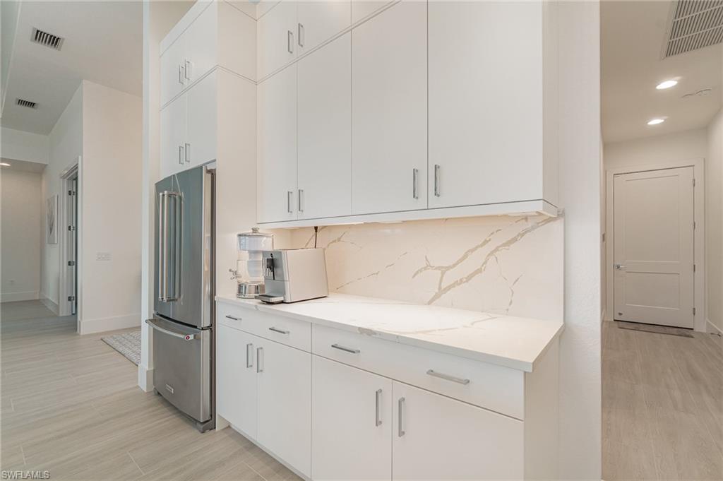 8900 Nevis Way Naples, FL 34112 - Photo 9 of 34 a kitchen with stainless steel appliances granite countertop a refrigerator and a sink