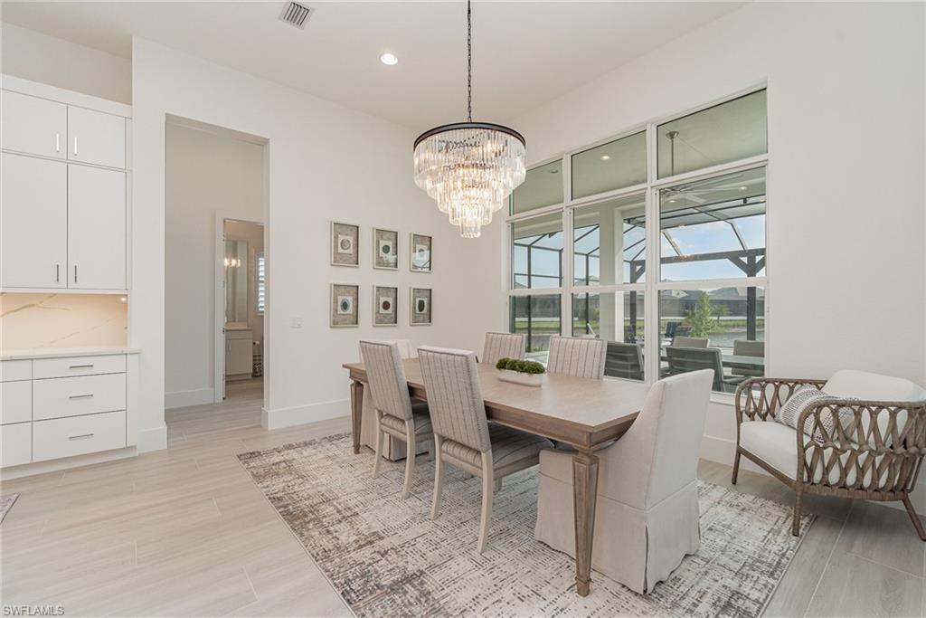 8900 Nevis Way Naples, FL 34112 - Photo 10 of 34 a view of a dining room with furniture window and outside view