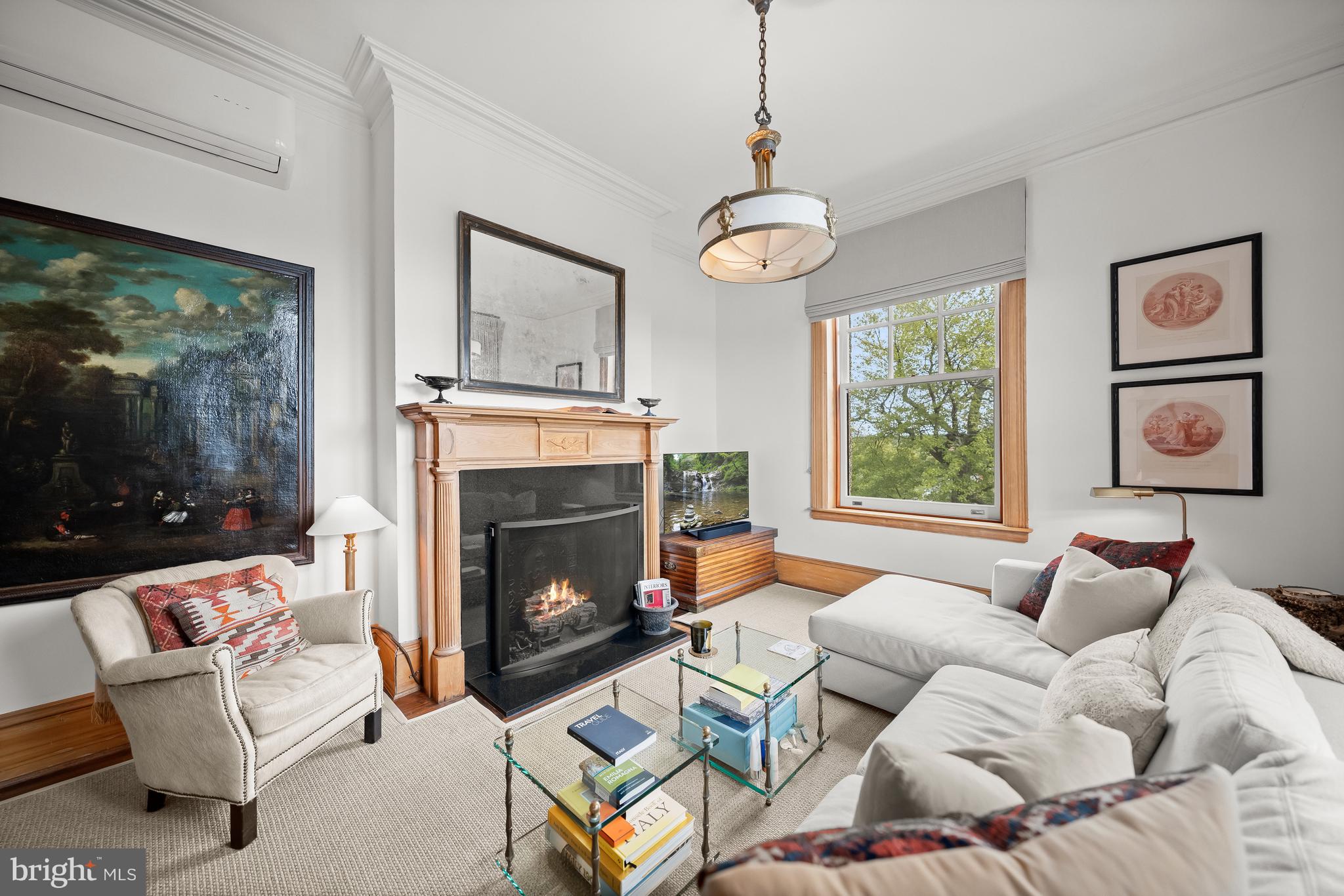 Gas fireplace with ornate wooden mantel