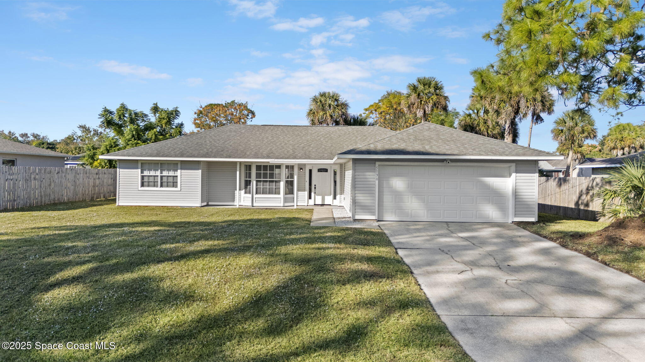 5130 Carter Street Cocoa, FL 32927 - Photo 1 of 33 a view of a yard in front of a house with a large tree