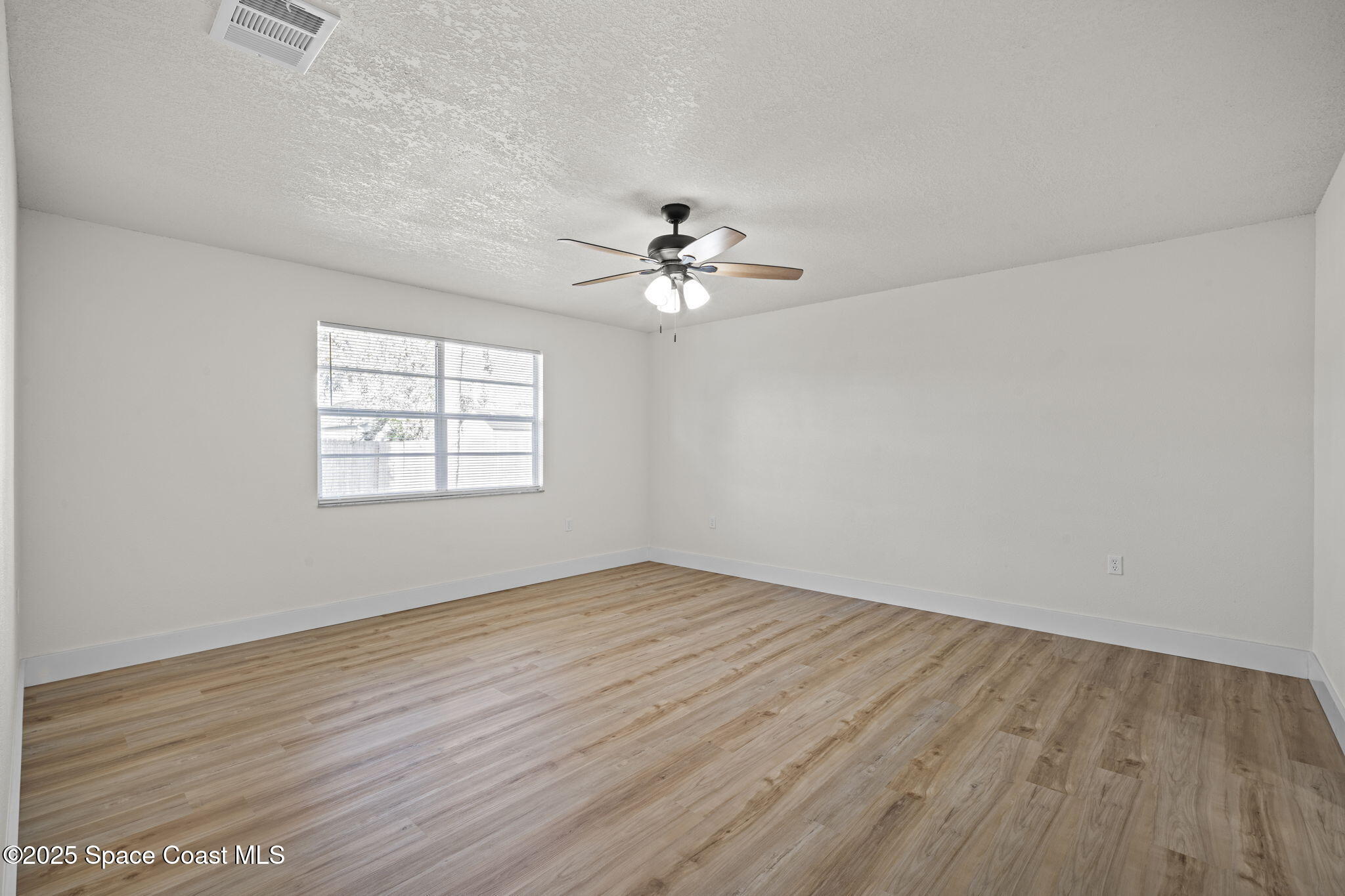 5130 Carter Street Cocoa, FL 32927 - Photo 16 of 33 wooden floor in an empty room with a window