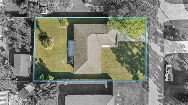 an aerial view of a house with a yard