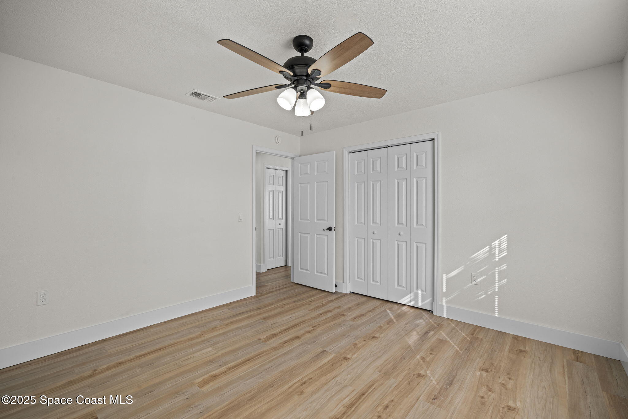 5130 Carter Street Cocoa, FL 32927 - Photo 24 of 33 wooden floor in an empty room with a window