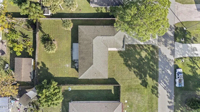 an aerial view of a house with a yard