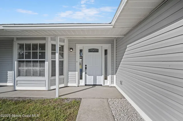 a front view of a house with a large window