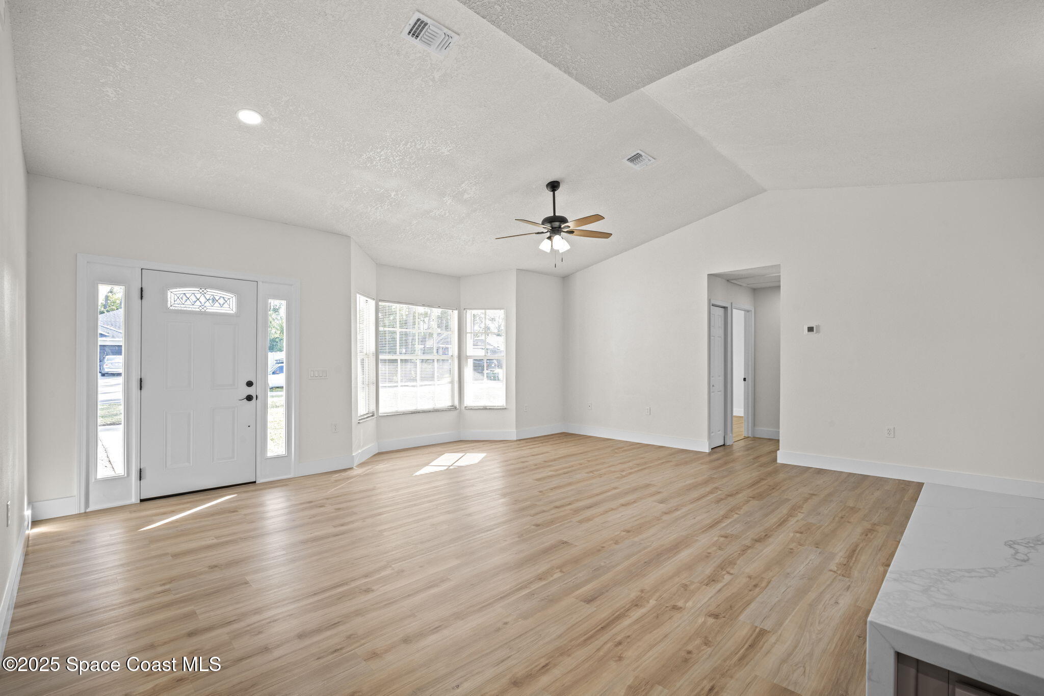 5130 Carter Street Cocoa, FL 32927 - Photo 5 of 33 a view of an empty room with wooden floor and a window