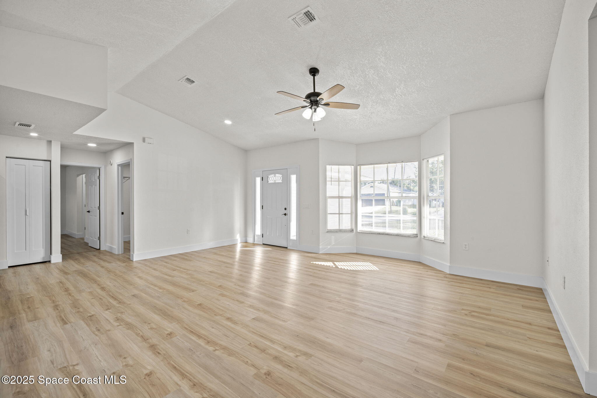 5130 Carter Street Cocoa, FL 32927 - Photo 6 of 33 a view of an empty room with a window and wooden floor