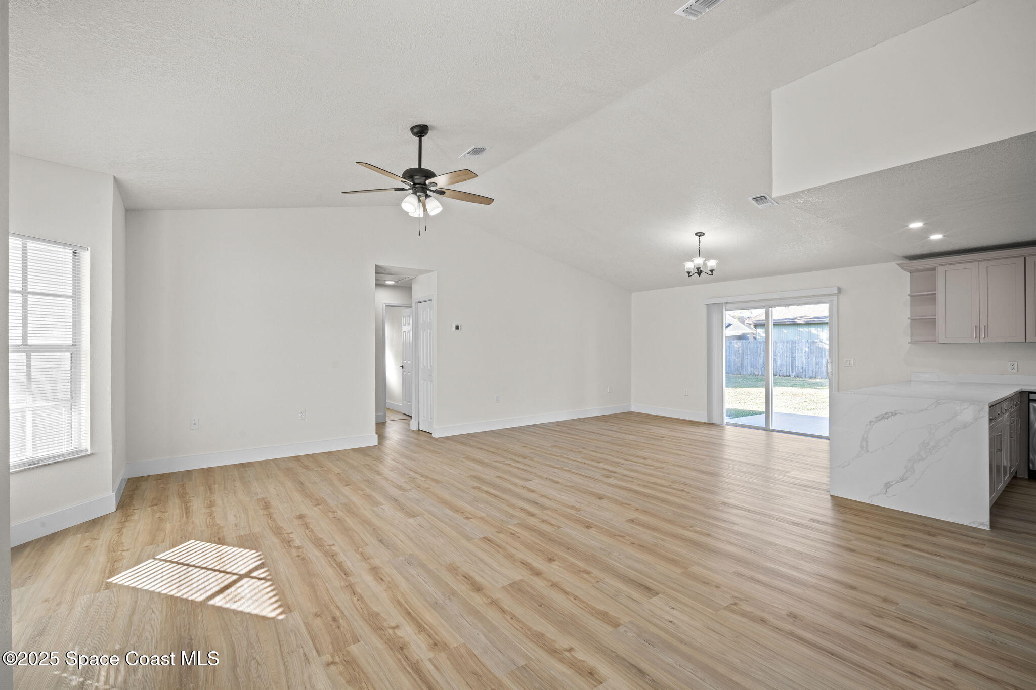 5130 Carter Street Cocoa, FL 32927 - Photo 7 of 33 a view of an empty room with a window and wooden floor
