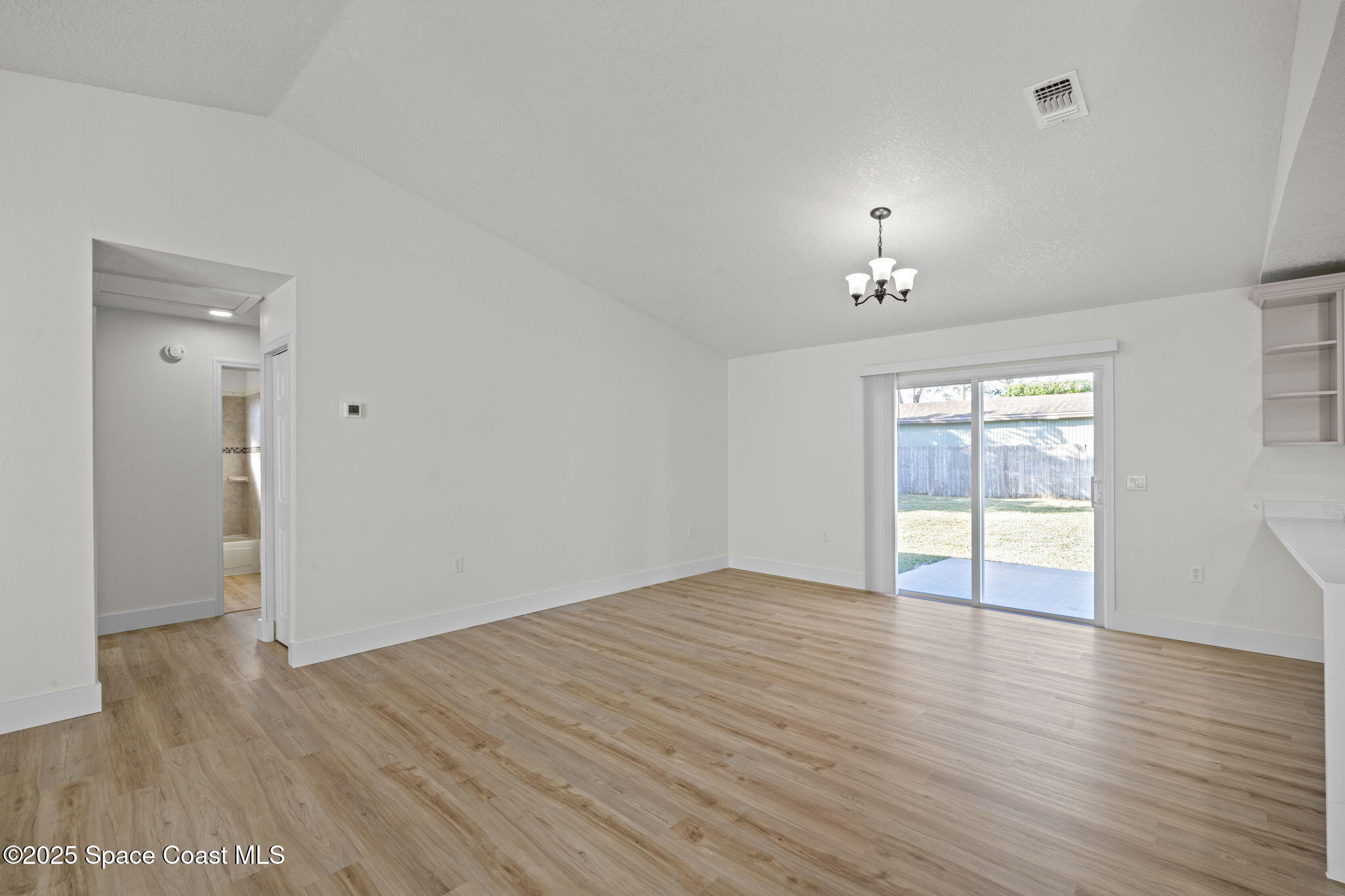 5130 Carter Street Cocoa, FL 32927 - Photo 8 of 33 an empty room with wooden floor and window