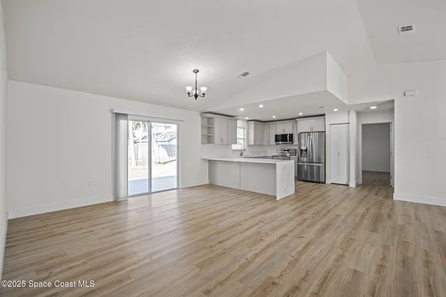 a view of kitchen with wooden floor and window