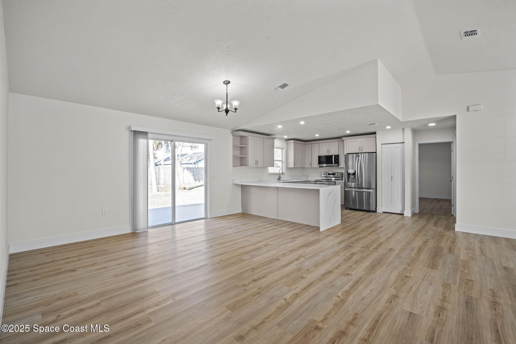 5130 Carter Street Cocoa, FL 32927 - Photo 9 of 33 a view of kitchen with wooden floor and window