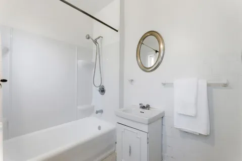 a bathroom with a bath tub and a sink