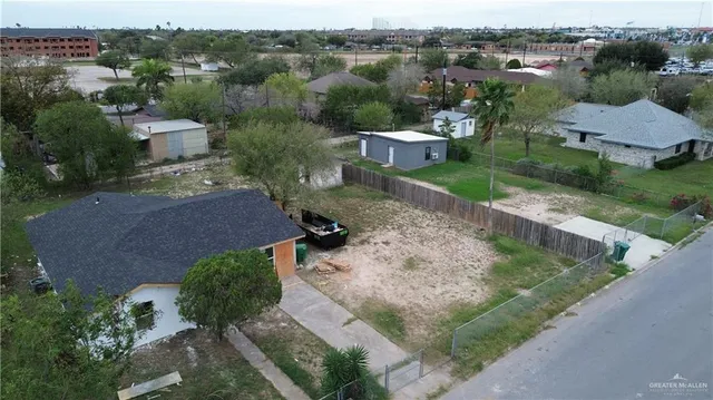 an aerial view of a house with yard