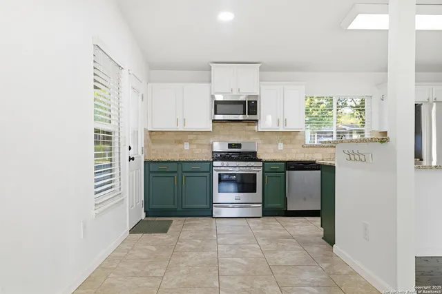 a kitchen with a stove a sink and a microwave