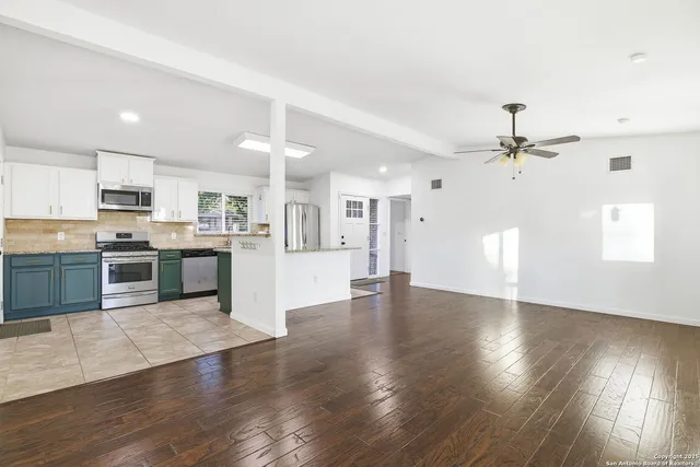 a view of kitchen with cabinets and wooden floor