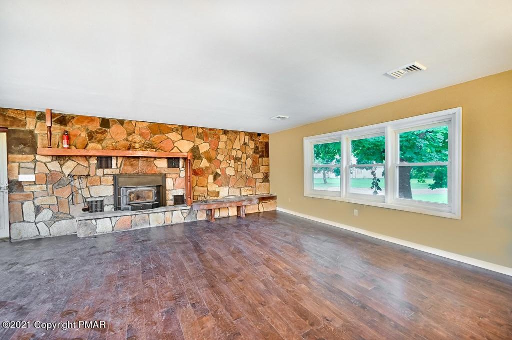 171 VanWhy Road Bushkill, PA 18324 - Photo 12 of 61 an empty room with sliding door and wooden floor