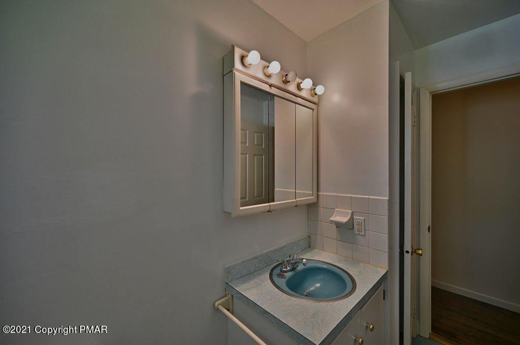171 VanWhy Road Bushkill, PA 18324 - Photo 16 of 61 a bathroom with a sink and vanity