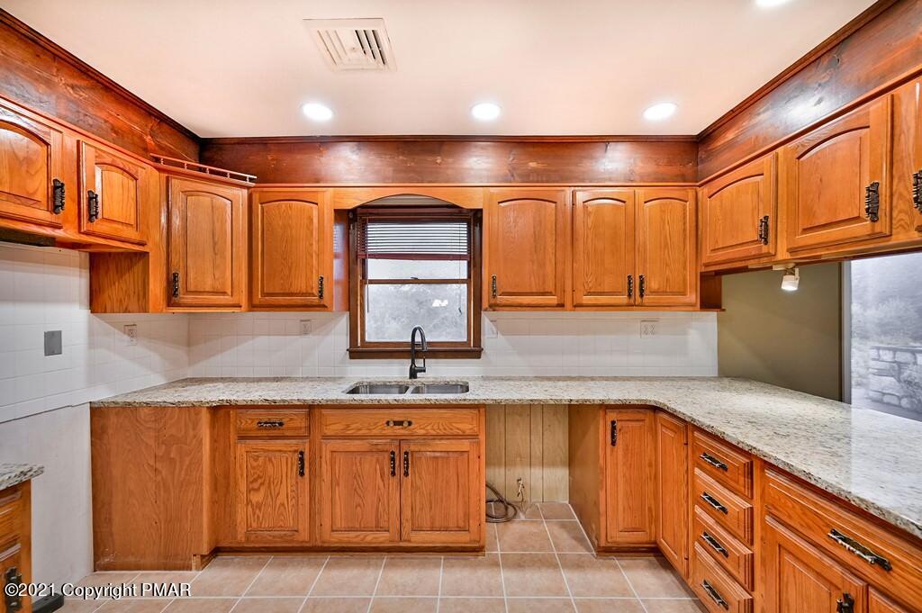 171 VanWhy Road Bushkill, PA 18324 - Photo 19 of 61 a large kitchen with granite countertop a sink and cabinets