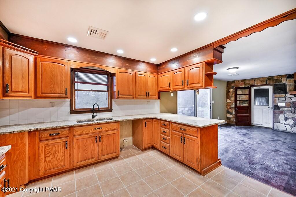 171 VanWhy Road Bushkill, PA 18324 - Photo 20 of 61 a kitchen with stainless steel appliances granite countertop a sink and cabinets
