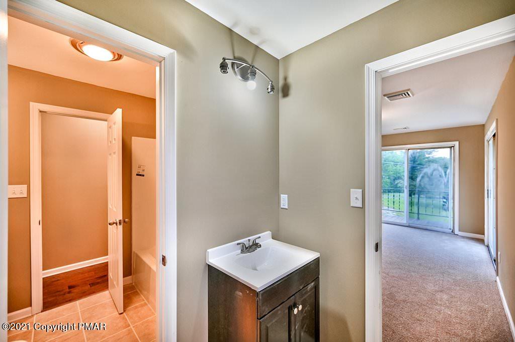 171 VanWhy Road Bushkill, PA 18324 - Photo 27 of 61 a bathroom with a sink a mirror and a shower