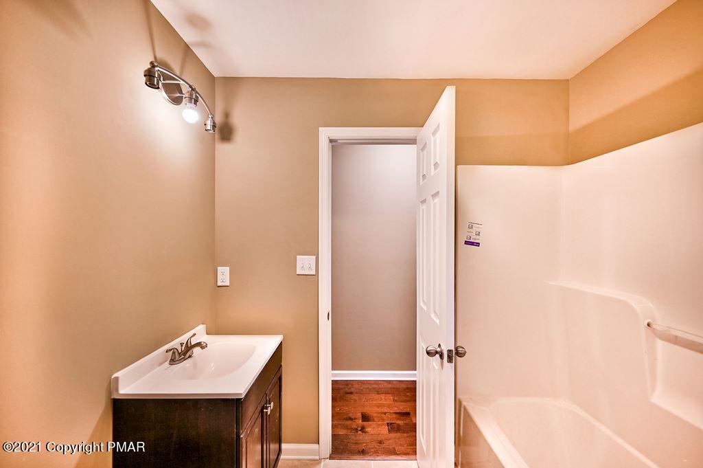 171 VanWhy Road Bushkill, PA 18324 - Photo 29 of 61 a bathroom with a sink a mirror and a shower