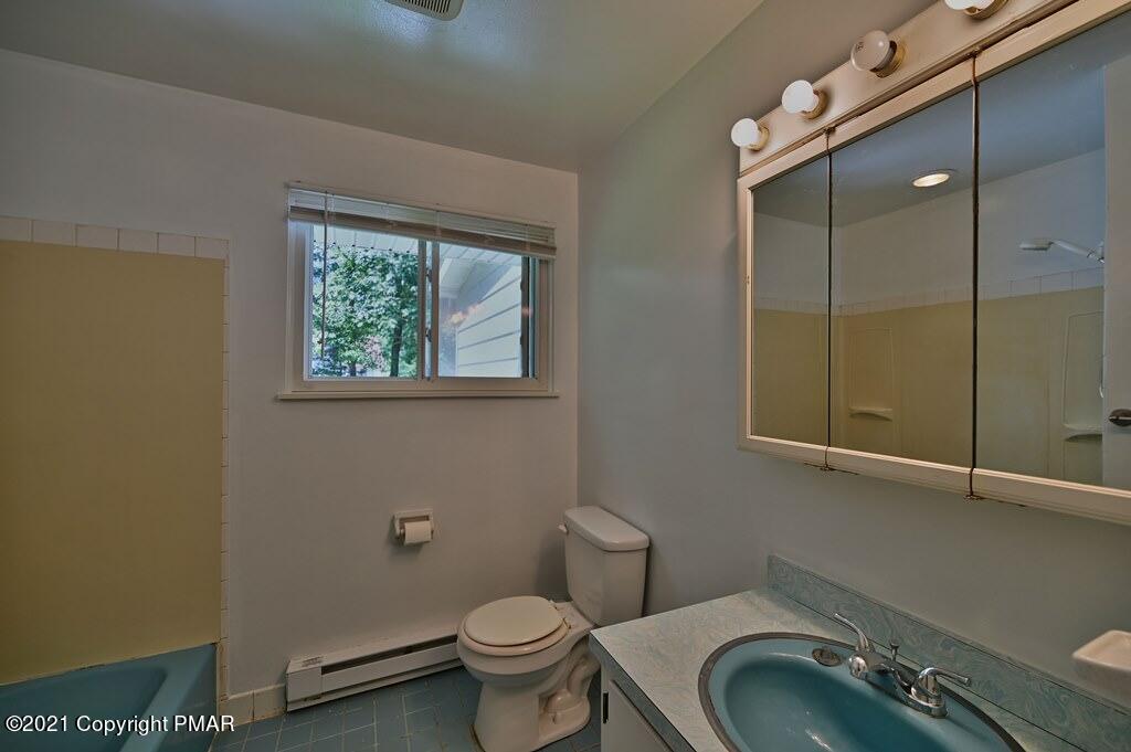 171 VanWhy Road Bushkill, PA 18324 - Photo 39 of 61 a bathroom with a granite countertop toilet sink and mirror