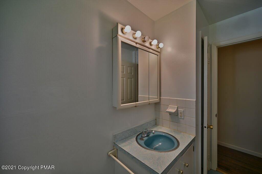 171 VanWhy Road Bushkill, PA 18324 - Photo 41 of 61 a bathroom with a sink and vanity