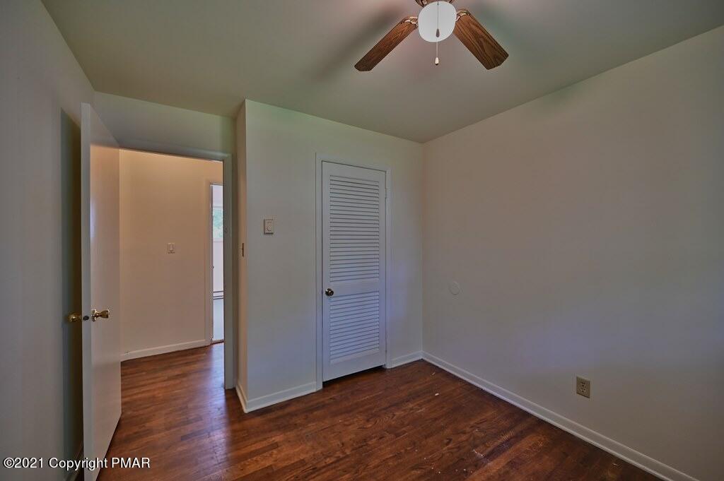 171 VanWhy Road Bushkill, PA 18324 - Photo 46 of 61 an empty room with wooden floor cabinet and windows