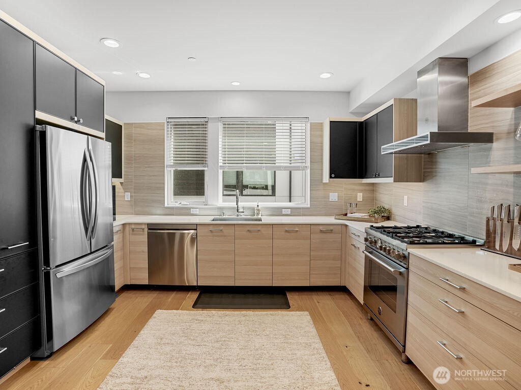 a kitchen with a refrigerator stove and sink