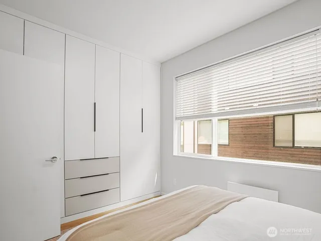 a bedroom with a bed and a window