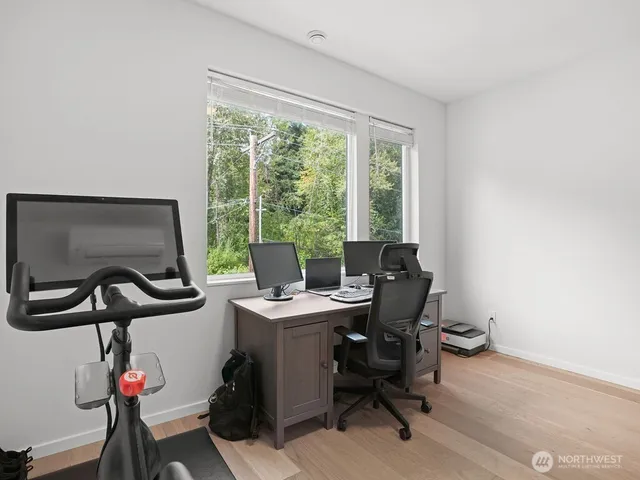 a view of a workspace with furniture and a window