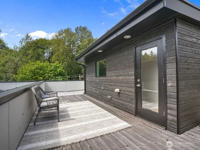 a view of a wooden floor and bench in the balcony