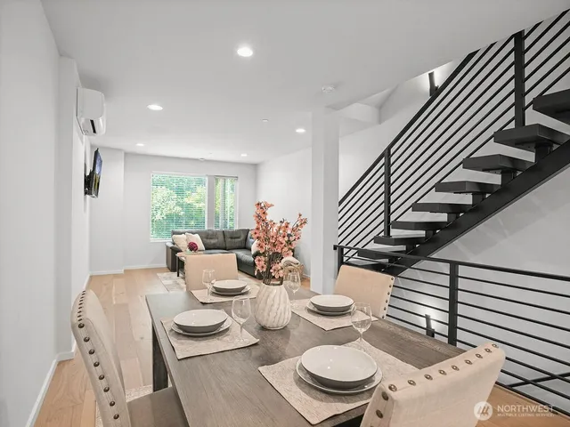 a dining room with furniture and wooden floor